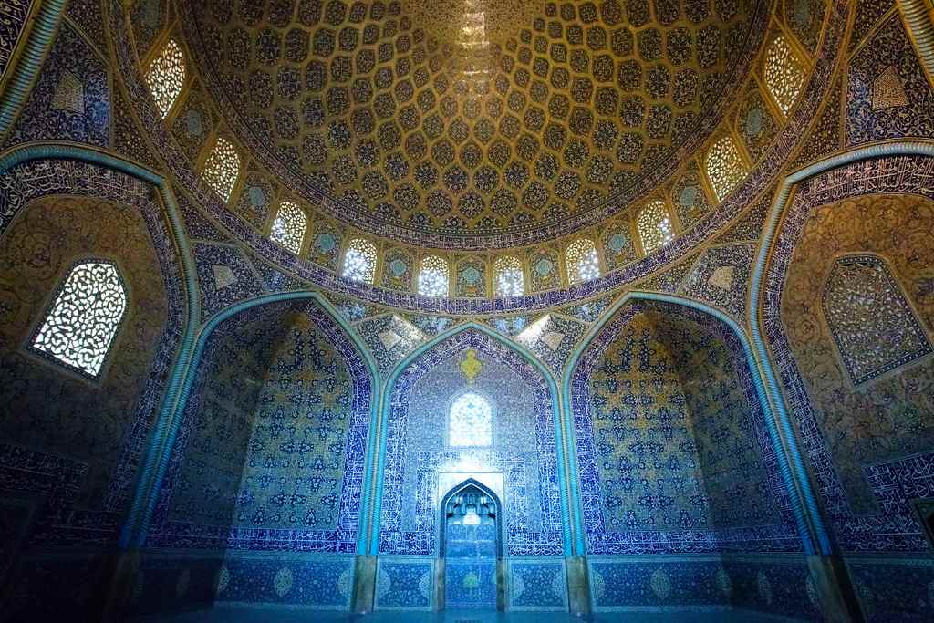 the blue and yellow tiled interier of a mosque in Isfahan