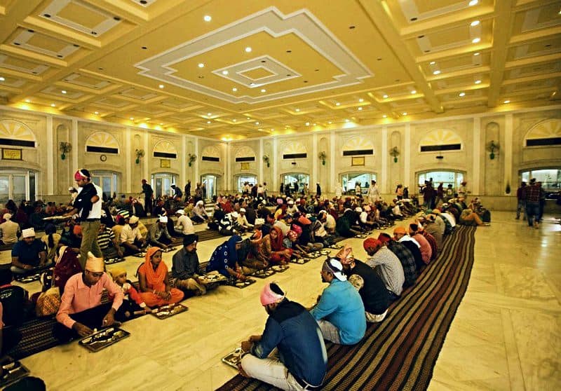 People sitting and eating in a Sikh temple