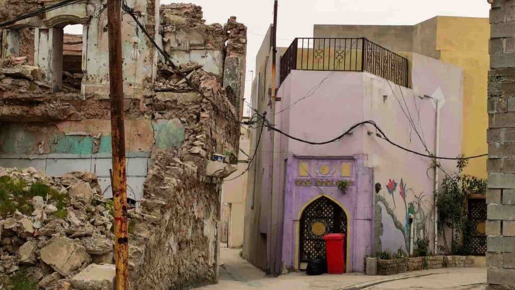 Ruined and renovated building next to each other in Mosul, in iraq